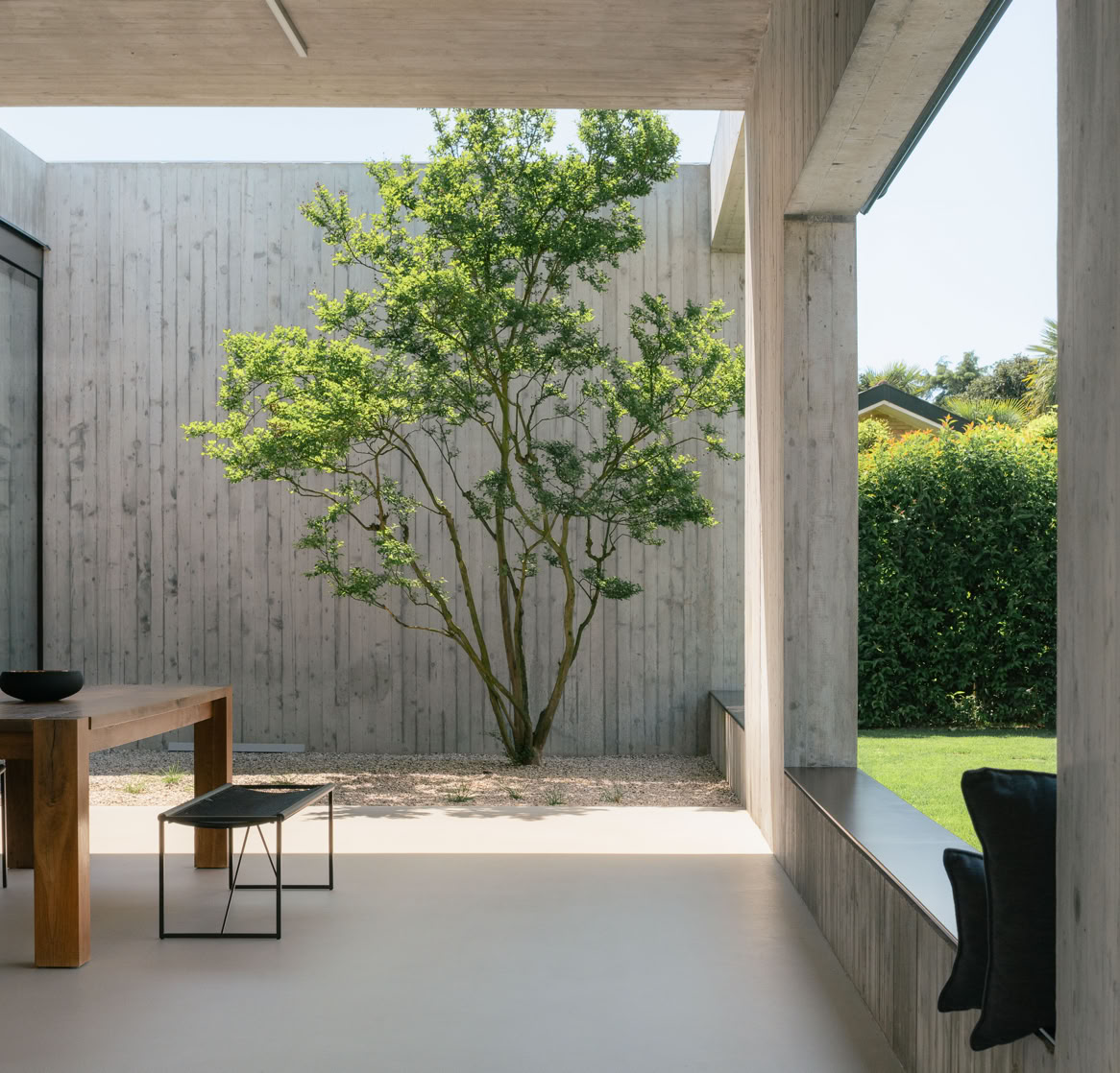 Carefully selected vegetation weaves between the concrete volumes, softening the architectural composition and enhancing its connection with the surrounding landscape.