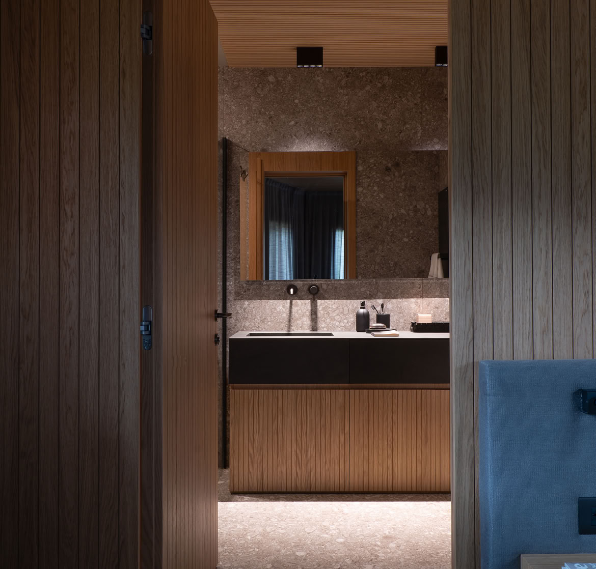 Intimate and welcoming interior with natural oak cladding and modern furnishings in Cortina penthouse.