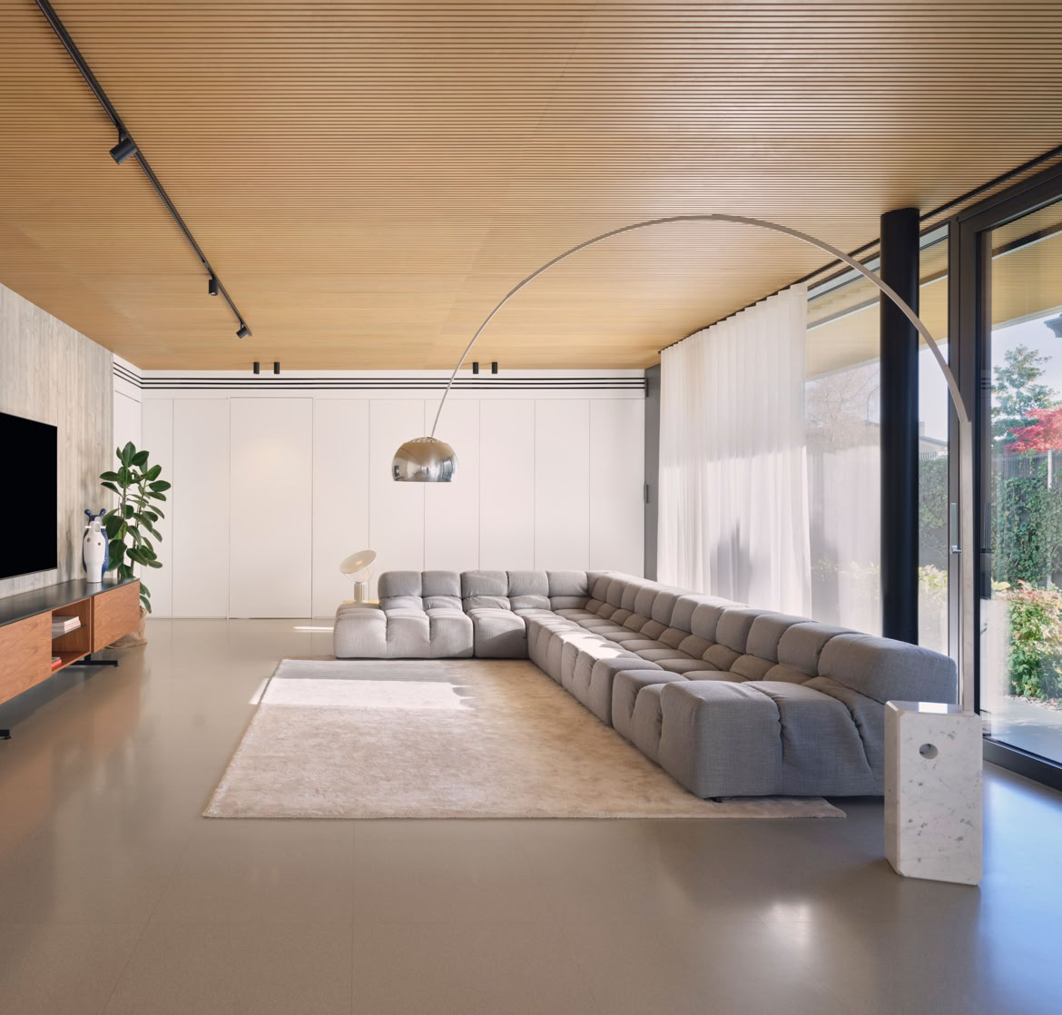 Surrounding portico connecting indoor and outdoor areas, creating a seamless flow between the living spaces and the landscaped garden.