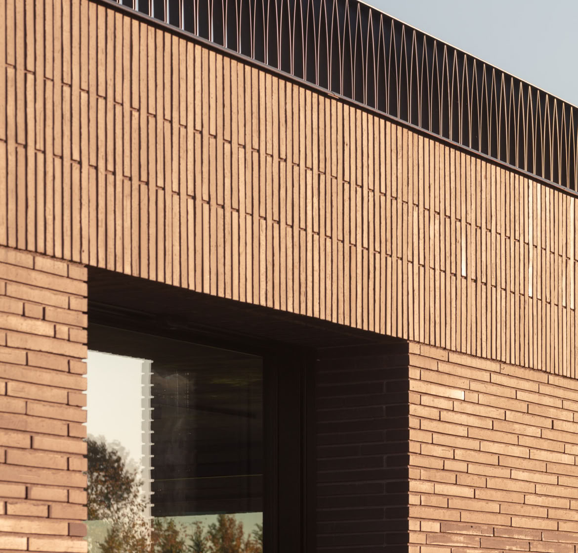 The exterior façades are clad in exposed brick by Fornace Sant’Anselmo, a premium-quality material that provides strength, long-lasting durability, and a distinctive architectural character.