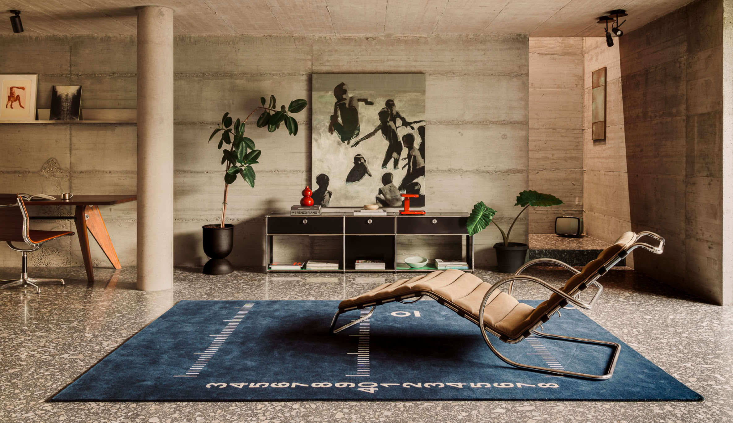A brutalist home defined by contemporary materials, developed by MIDE architetti. Pictured here is the ground-floor lounge area featuring curated designer furniture pieces.