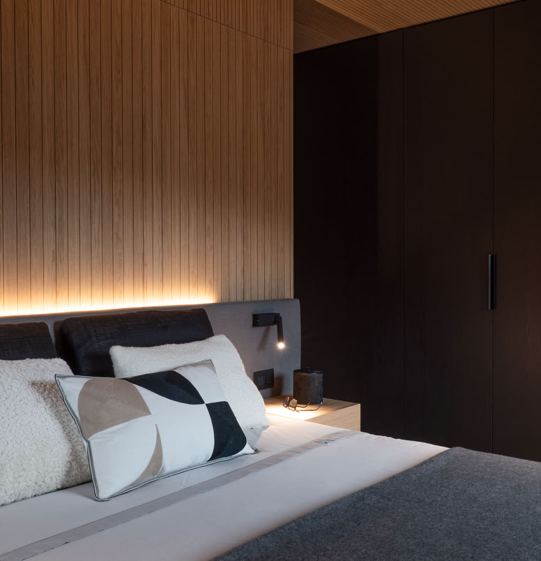 Intimate and welcoming interior with natural oak cladding and modern furnishings in Cortina penthouse.