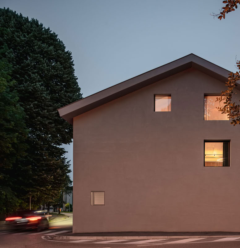 Facciata contemporanea caratterizzata da linee pulite, materiali autentici e grandi aperture che valorizzano luce e prospettive.