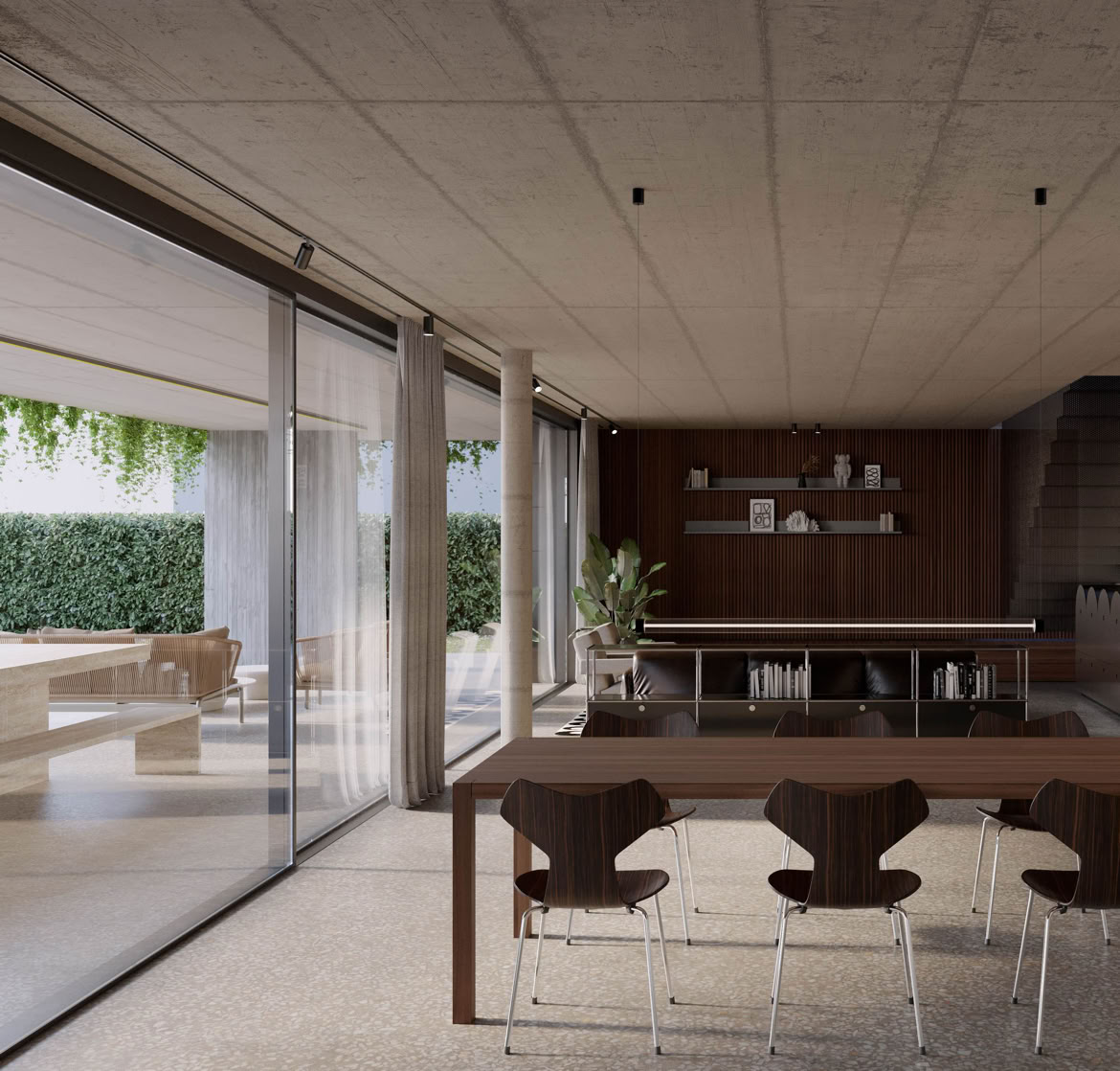 Gli interni principali con ampie vetrate a tutta altezza si aprono verso il giardino e la piscina, valorizzando luce naturale e continuità visiva.