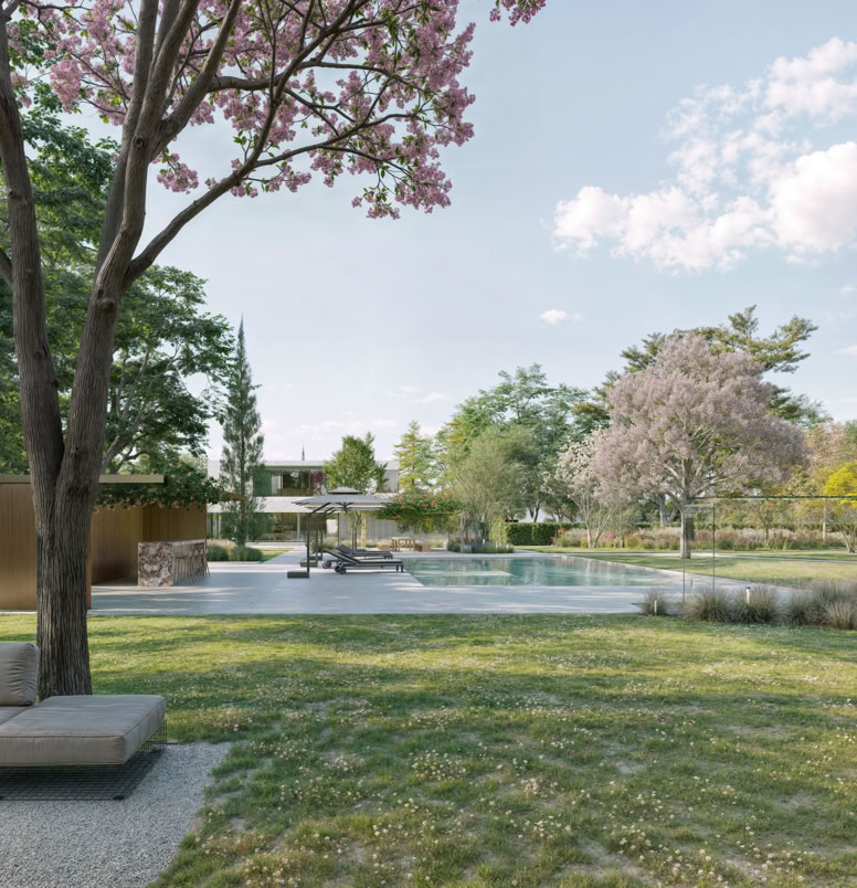 Vista sul giardino privato, in cui la vegetazione mediterranea incornicia la villa, creando un equilibrio tra architettura e natura.